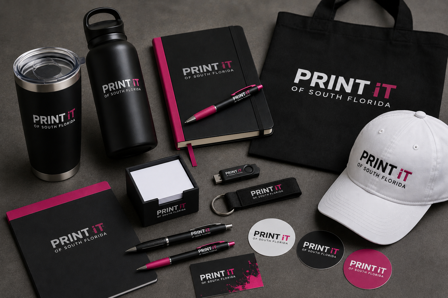 Branded promotional products from Print It of South Florida including a tumbler, water bottle, notebooks, pens, tote bag and cap