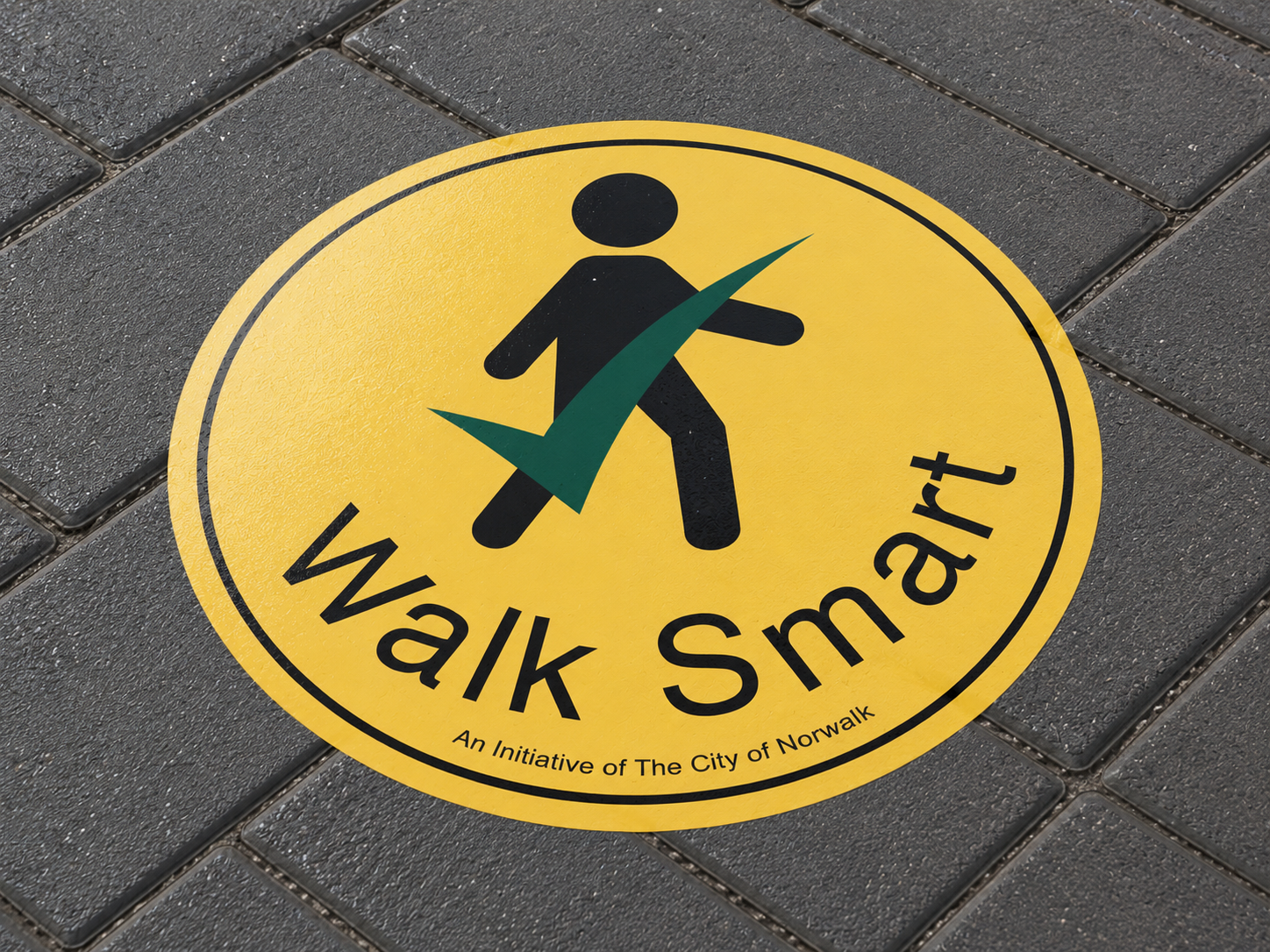 Walk Smart pedestrian safety decal on sidewalk