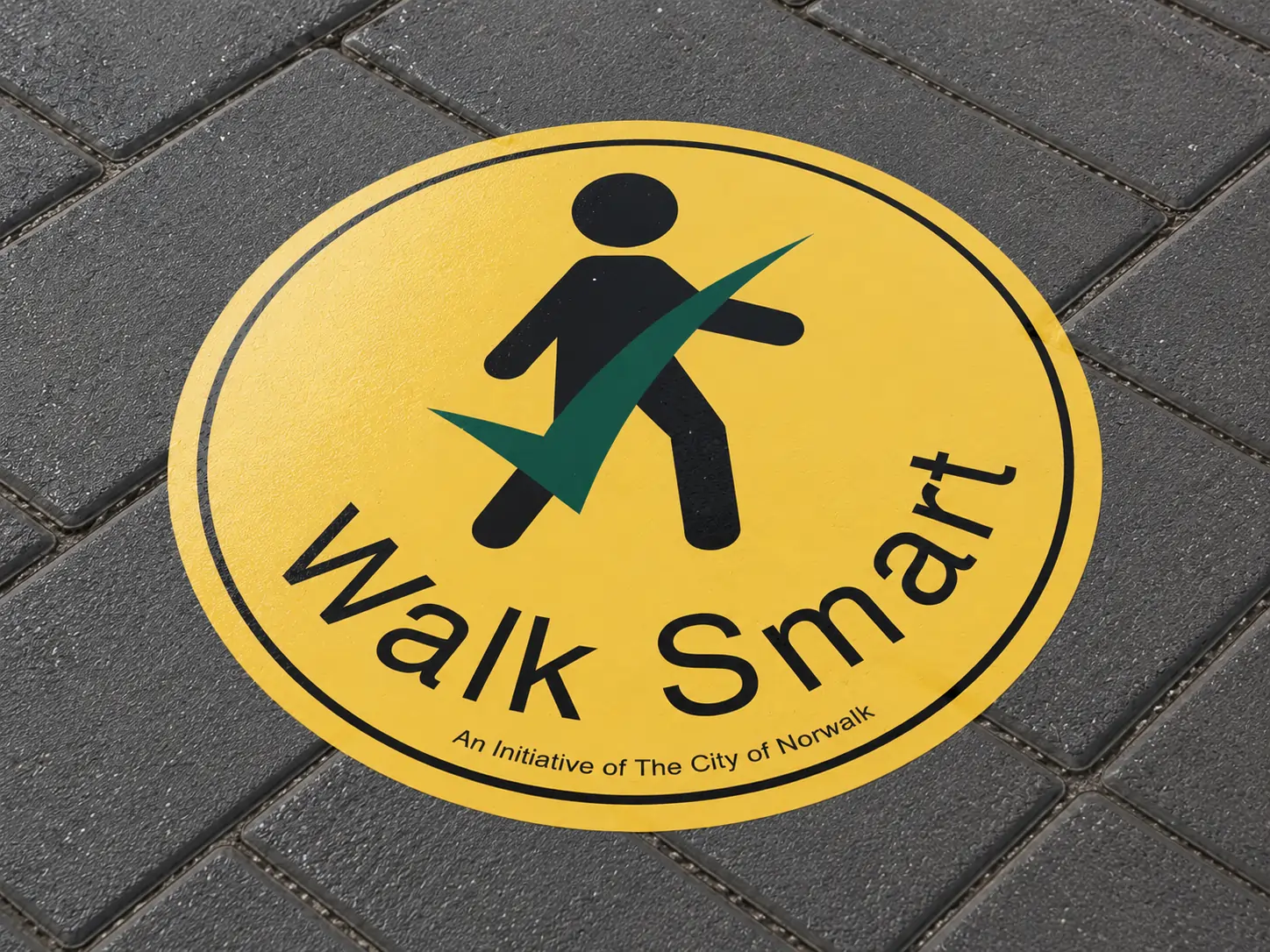 Walk Smart pedestrian decal applied to a paved sidewalk